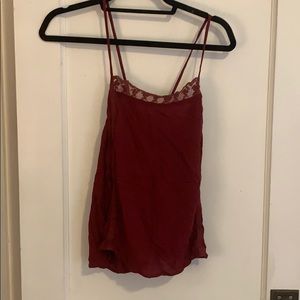 Wine colored top with cross in back